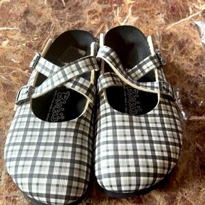 Black and white checkered Birkenstock clogs.